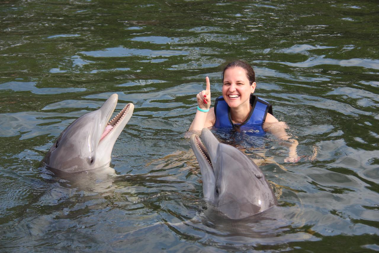 dolphins-plus-girl-pointing-up-with-two-dolphins